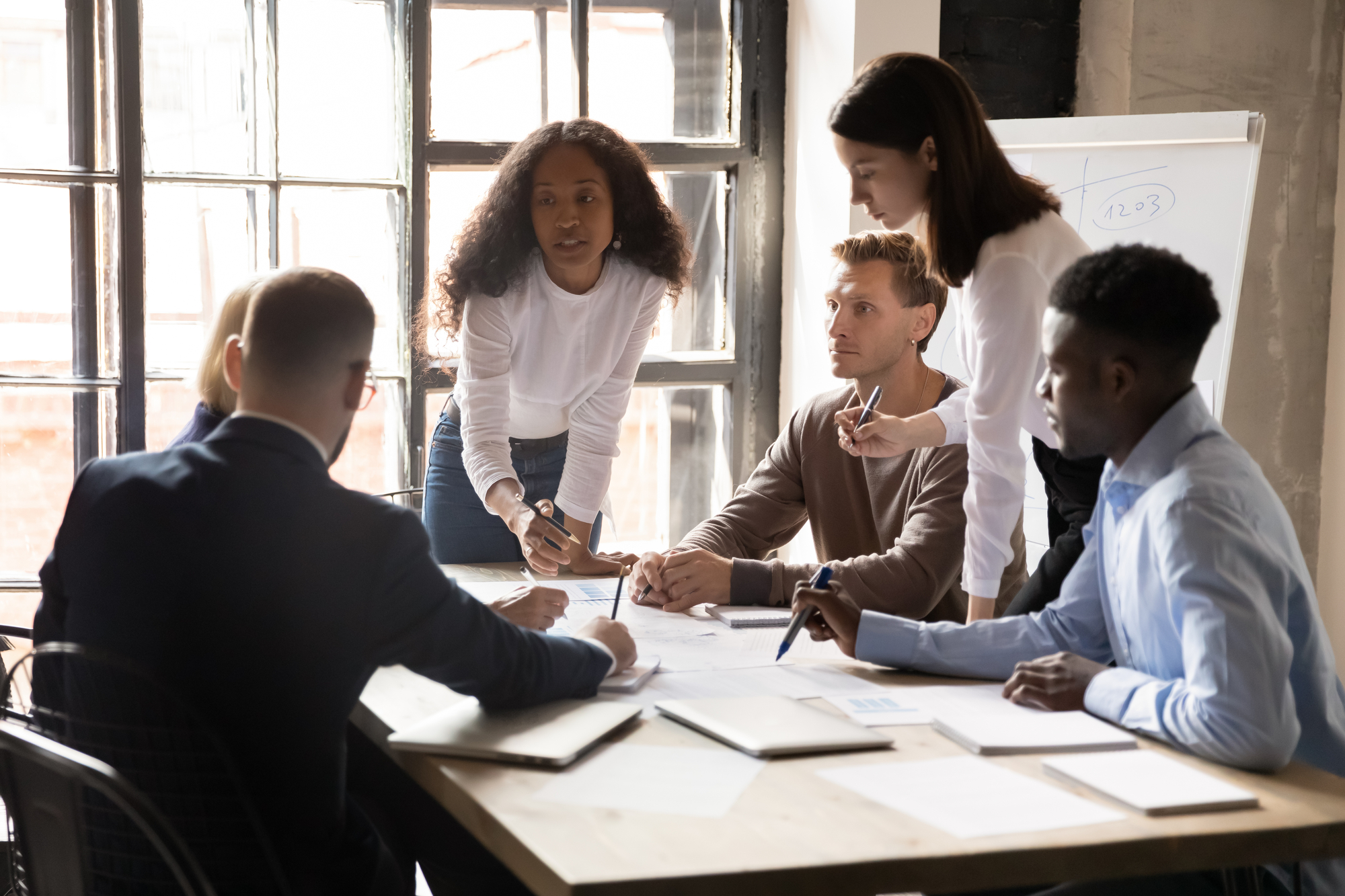 Diverse Business Team People Discuss Paperwork